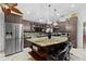 Kitchen with stainless steel refrigerator, granite countertops, and stylish light fixtures at 8105 N Grady Ave, Tampa, FL 33614