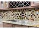 Kitchen sink with granite countertops, stylish backsplash, and stainless steel appliances at 8105 N Grady Ave, Tampa, FL 33614