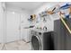 Laundry room equipped with modern, front-loading washer and dryer, plus plenty of shelf space for storage at 8105 N Grady Ave, Tampa, FL 33614