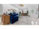 Open-concept living room boasts gorgeous marble floors, a modern ceiling fan, and lots of decor and plants at 8105 N Grady Ave, Tampa, FL 33614