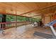 Expansive covered patio with wood ceiling, red tiled floors, outdoor seating, and a backyard view at 8105 N Grady Ave, Tampa, FL 33614
