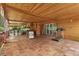 Large covered patio area with an outdoor kitchen, seating areas, and backyard access, perfect for entertaining at 8105 N Grady Ave, Tampa, FL 33614