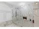 Beautiful shower with marble tiling, modern fixtures, and glass enclosure at 8105 N Grady Ave, Tampa, FL 33614
