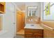 Bathroom featuring a single sink vanity, updated shower, and decorative stained glass window at 917 Pineview Ave, Clearwater, FL 33756