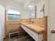 Bathroom with a unique sink and vanity, accented by colored tile and a stained glass window at 917 Pineview Ave, Clearwater, FL 33756