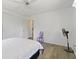 Bright bedroom with hardwood floors, neutral walls, ceiling fan and white bed at 917 Pineview Ave, Clearwater, FL 33756
