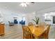 Open dining and living area featuring hardwood floors, neutral walls, and lots of seating at 917 Pineview Ave, Clearwater, FL 33756