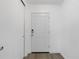 A front entryway featuring a white door, clean lines, and minimalist design for a modern and welcoming feel at 917 Pineview Ave, Clearwater, FL 33756