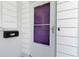 Close-up of a white front door with glass window, black mailbox, and house number for added curb appeal at 917 Pineview Ave, Clearwater, FL 33756