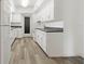 Bright kitchen featuring white cabinets, modern countertops, and stainless steel appliances at 917 Pineview Ave, Clearwater, FL 33756