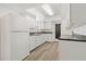 Bright kitchen featuring white cabinets, modern countertops, and stainless steel appliances at 917 Pineview Ave, Clearwater, FL 33756
