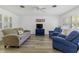 Bright living room featuring hardwood floors, neutral walls, and comfortable seating at 917 Pineview Ave, Clearwater, FL 33756