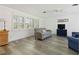 Bright living room features new floors, plantation shutters, and neutral walls providing a clean, modern aesthetic at 917 Pineview Ave, Clearwater, FL 33756