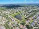 Aerial view of the neighborhood near a lake featuring lush green landscaping at 10523 Boyette Creek Blvd, Riverview, FL 33569