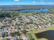 High angle drone shot of community near a lake with lush green surroundings at 10523 Boyette Creek Blvd, Riverview, FL 33569