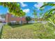 Expansive backyard with lush green grass, partial fencing, and mature trees at 10523 Boyette Creek Blvd, Riverview, FL 33569