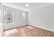 Bright bedroom with wood-look floors, lots of light, and neutral paint at 10523 Boyette Creek Blvd, Riverview, FL 33569