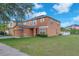 Side view of a two-story home with a well-maintained lawn under a blue sky at 10523 Boyette Creek Blvd, Riverview, FL 33569