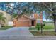 Charming two-story home with a two-car garage and manicured lawn at 10523 Boyette Creek Blvd, Riverview, FL 33569