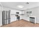 Modern kitchen boasts stainless steel appliances, white cabinets, and quartz countertops at 10523 Boyette Creek Blvd, Riverview, FL 33569