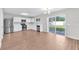 Modern kitchen with white cabinets, stainless steel appliances, and hardwood floors at 10523 Boyette Creek Blvd, Riverview, FL 33569