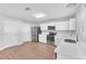 Kitchen with stainless steel appliances, white cabinets and hardwood floors at 10523 Boyette Creek Blvd, Riverview, FL 33569