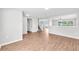 Bright, open-concept living area with hardwood floors, staircase, and recessed lighting at 10523 Boyette Creek Blvd, Riverview, FL 33569