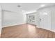 Inviting living room featuring hardwood floors, large window, and a modern ceiling light at 10523 Boyette Creek Blvd, Riverview, FL 33569