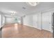 Bright, open-concept living room featuring light wood floors and modern lighting fixtures at 10523 Boyette Creek Blvd, Riverview, FL 33569