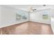 Upstairs living room with windows that provide lots of natural light and beautiful hardwood floors at 10523 Boyette Creek Blvd, Riverview, FL 33569