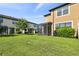 Well-maintained backyard featuring green grass, landscaping, and a screened lanai at 11519 Crowned Sparrow Ln, Tampa, FL 33626