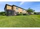 Spacious backyard with green grass, landscaping, and a screened lanai at 11519 Crowned Sparrow Ln, Tampa, FL 33626