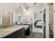Bathroom vanity featuring granite countertop and black cabinets adjacent to bedroom and toilet room at 11519 Crowned Sparrow Ln, Tampa, FL 33626