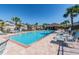A sparkling community pool offers a refreshing escape, complemented by ample seating, lush palms, and a clubhouse at 11519 Crowned Sparrow Ln, Tampa, FL 33626