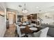 Open concept dining room with dark wood table, modern chandelier and view of the kitchen and staircase at 11519 Crowned Sparrow Ln, Tampa, FL 33626
