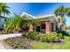 Community clubhouse featuring brick accents, lush landscaping, and a welcoming entrance at 11519 Crowned Sparrow Ln, Tampa, FL 33626