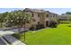 Charming two-story townhome with lush green lawn and a small pond at 11519 Crowned Sparrow Ln, Tampa, FL 33626