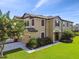 Charming two-story townhome with a two-car garage, decorative shutters, and well-maintained landscaping at 11519 Crowned Sparrow Ln, Tampa, FL 33626