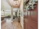 Grand foyer with wood-look tile flooring, elegant lighting, and an open-concept view to living and dining areas at 11519 Crowned Sparrow Ln, Tampa, FL 33626