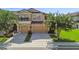 Charming two-story townhome with a two-car garage, a small balcony, and a well-manicured front lawn at 11519 Crowned Sparrow Ln, Tampa, FL 33626
