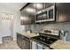 Well-equipped kitchen with stainless steel microwave and range, granite countertops, and subway tile backsplash at 11519 Crowned Sparrow Ln, Tampa, FL 33626