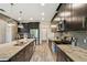 Modern kitchen featuring stainless steel appliances, granite countertops, dark cabinetry and stylish pendant lighting at 11519 Crowned Sparrow Ln, Tampa, FL 33626