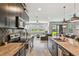 Open-concept kitchen leading to a cozy living area, with stainless steel appliances and granite countertops at 11519 Crowned Sparrow Ln, Tampa, FL 33626