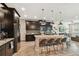 Spacious kitchen with dark cabinets, stainless steel appliances, large island with seating, and ample counter space at 11519 Crowned Sparrow Ln, Tampa, FL 33626