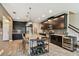 Gourmet kitchen with dark cabinetry, a wine fridge, stainless appliances, and a large island with bar seating at 11519 Crowned Sparrow Ln, Tampa, FL 33626