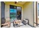 Cozy screened lanai with outdoor seating and view to home interior at 11519 Crowned Sparrow Ln, Tampa, FL 33626