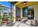 Screened lanai featuring comfortable seating with views of the backyard at 11519 Crowned Sparrow Ln, Tampa, FL 33626