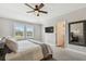Inviting main bedroom features a ceiling fan, plush carpet, and plantation shutters at 11519 Crowned Sparrow Ln, Tampa, FL 33626