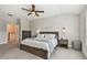 Large main bedroom with wood furnishings, ceiling fan, and natural light from a nearby window at 11519 Crowned Sparrow Ln, Tampa, FL 33626