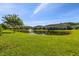 Community pond surrounded by lush green grass on a bright day at 11519 Crowned Sparrow Ln, Tampa, FL 33626